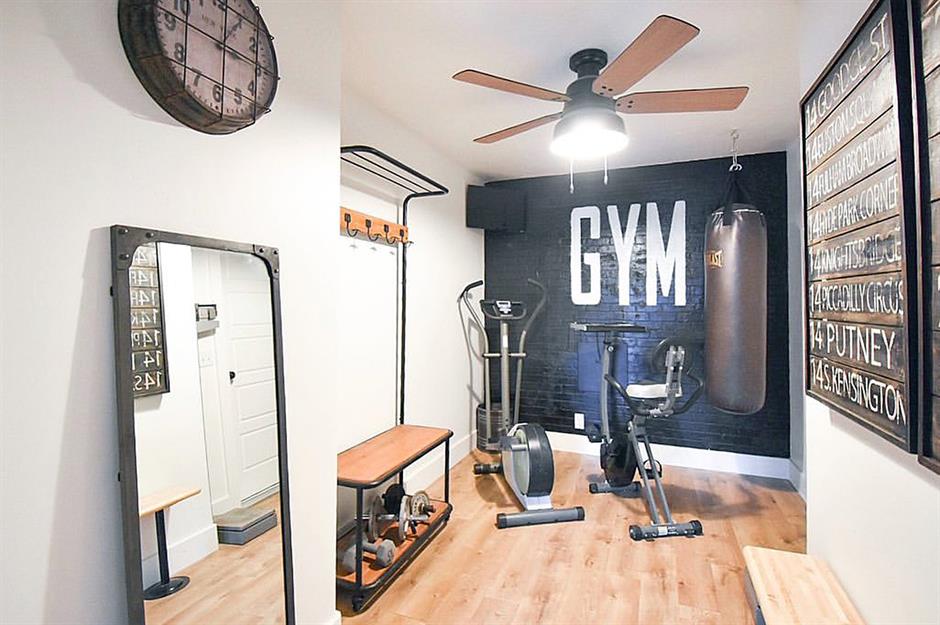 small home gym with a punching bag, exercise bike, and elliptical