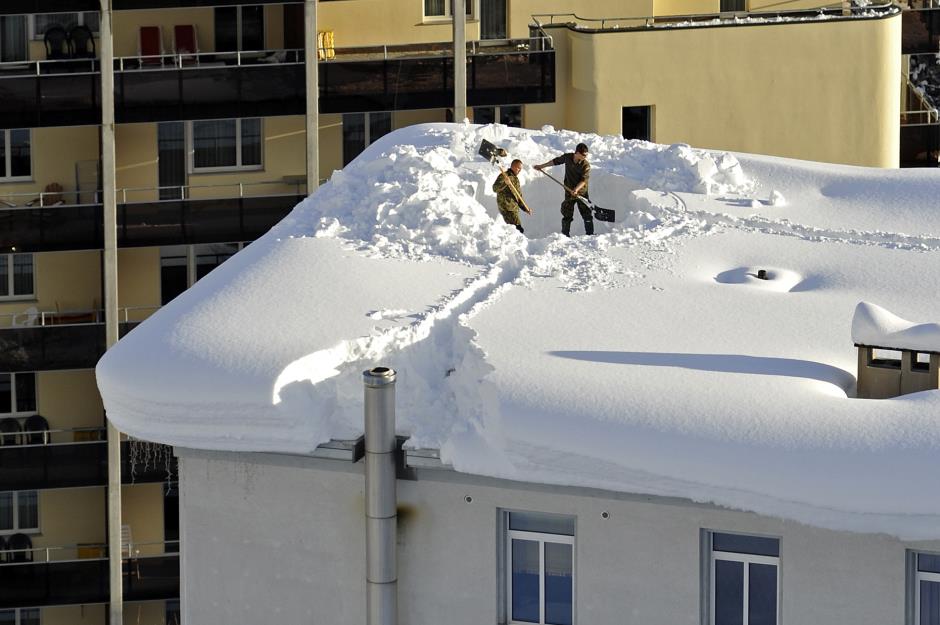 Houses straining under snowfall, Graubünden, Switzerland