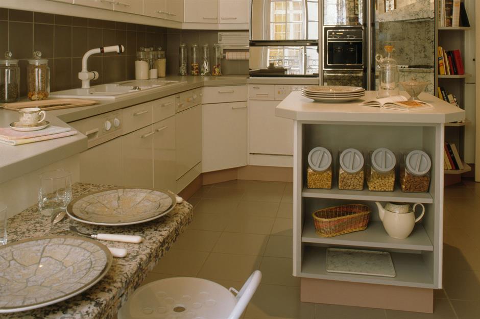 Kitchen with white stone countertops, solid wood cabinets, and vintage tile  on the walls Stock Photo - Alamy