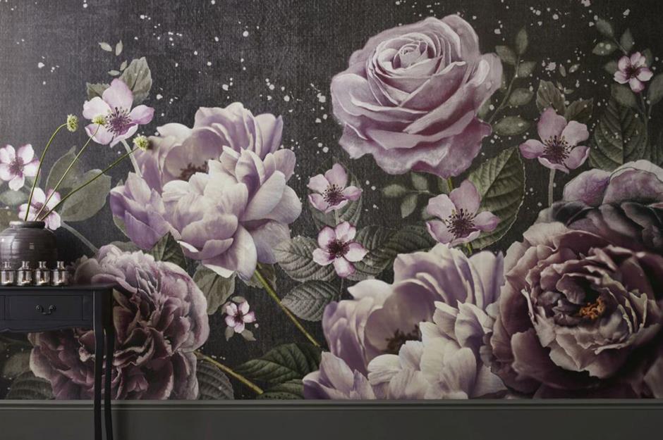 A mural with pink oversized florals against a dark background