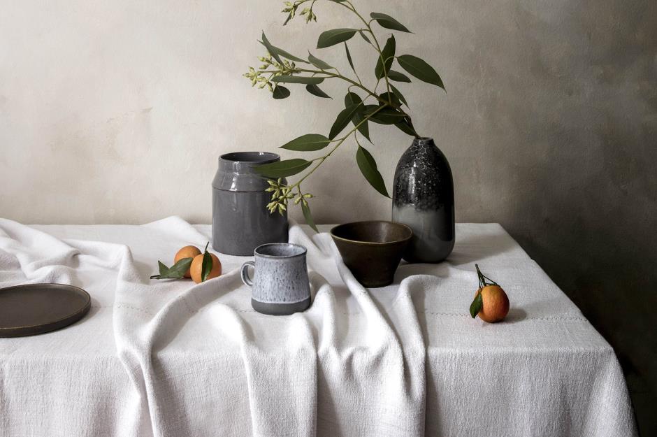 Ceramic vases on a table with a linen tablecloth