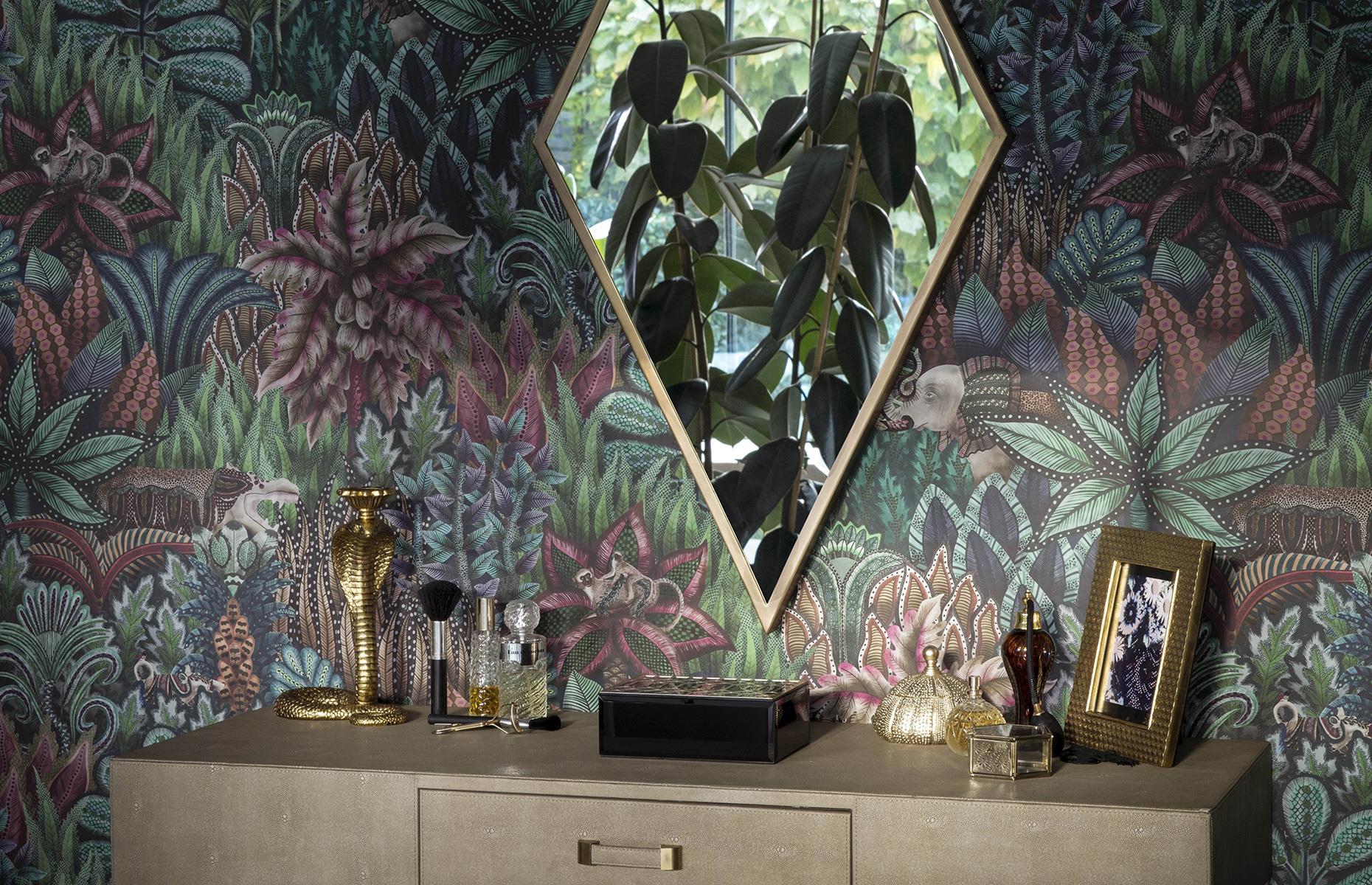 Dark jungle-inspired wallpaper and console table and diamond-shaped mirror 
