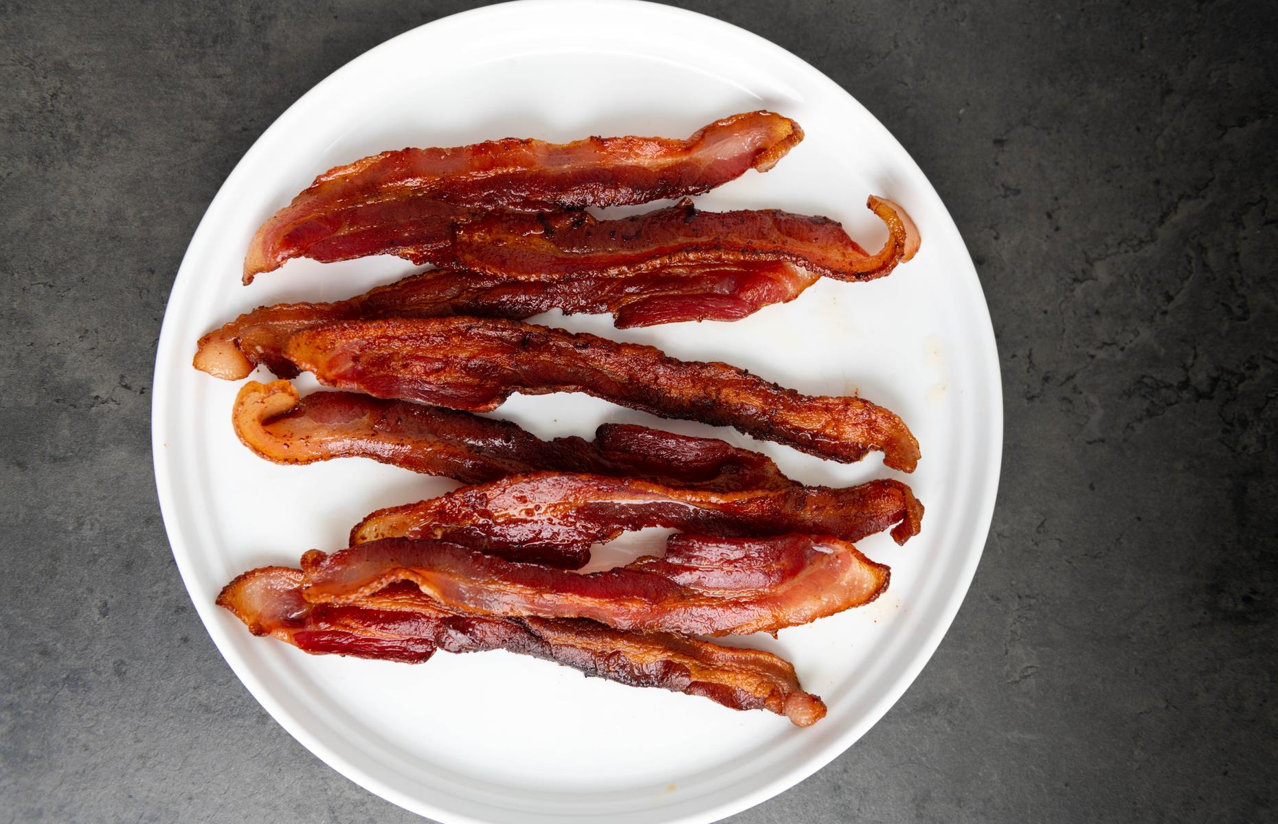 Why are nitrates in bacon a cancer risk?