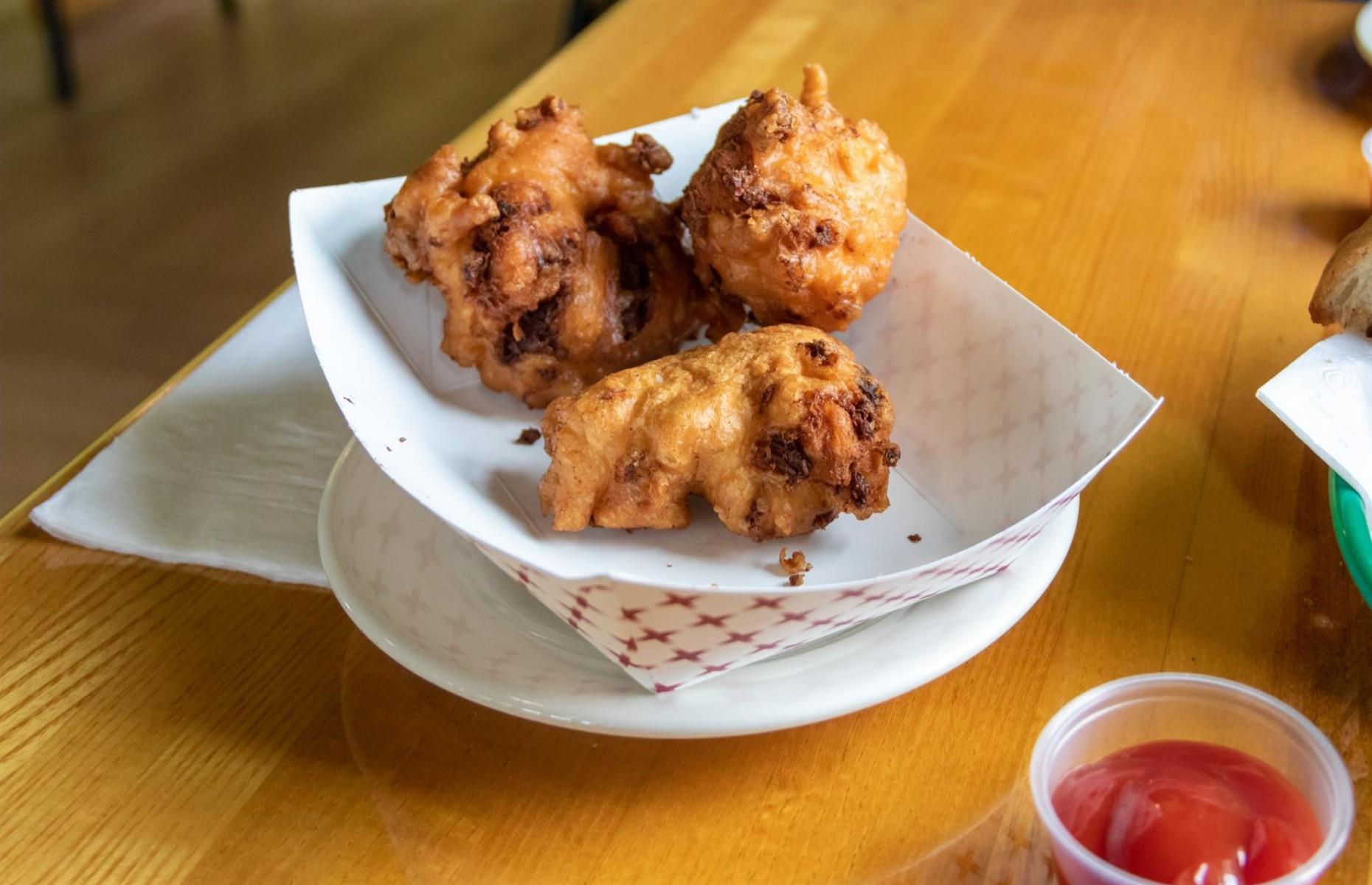 Rhode Island: eat clam cakes from a seafood shack