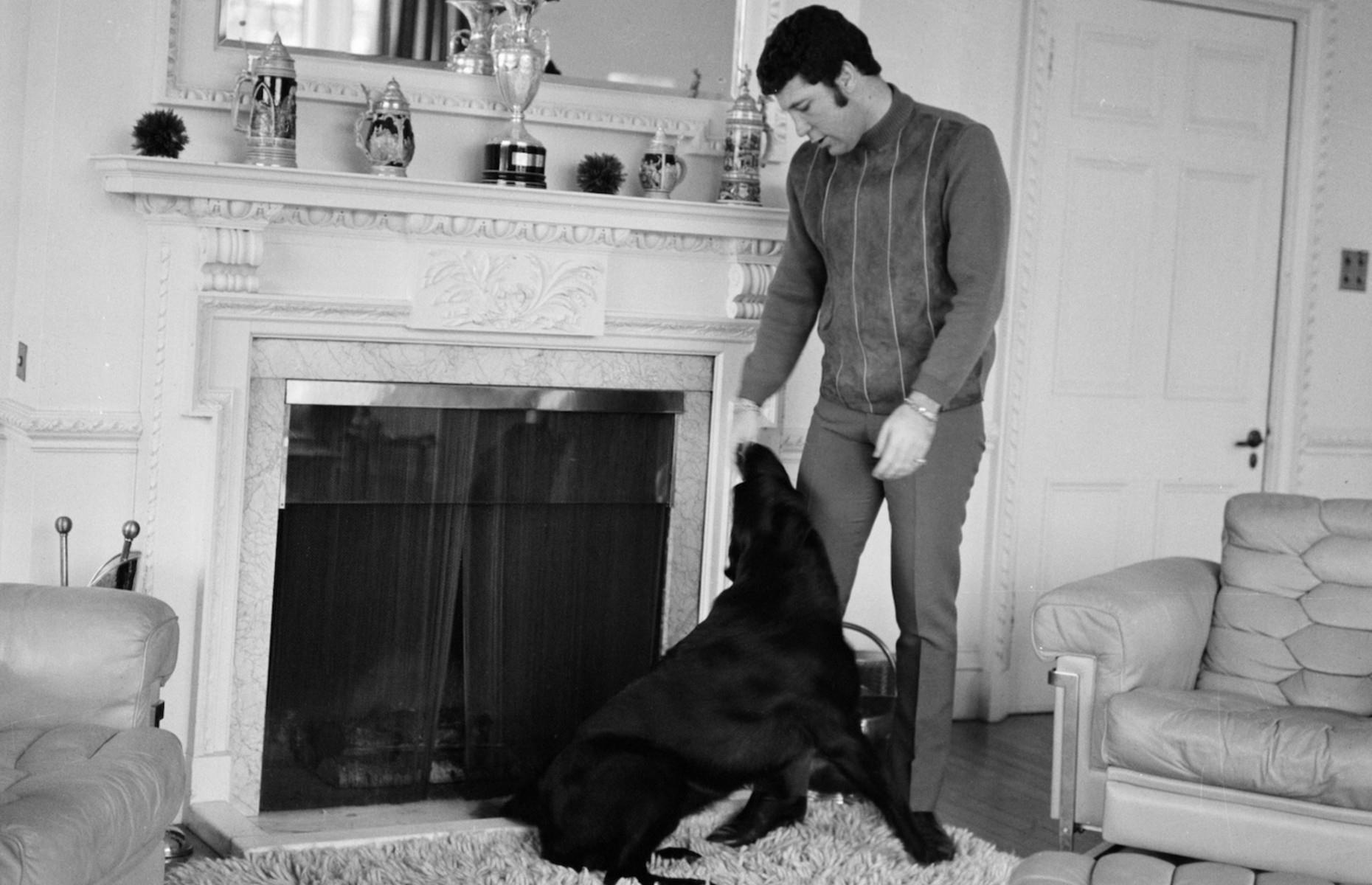 1968: Sir Tom Jones relaxes with his pet dog in Surrey
