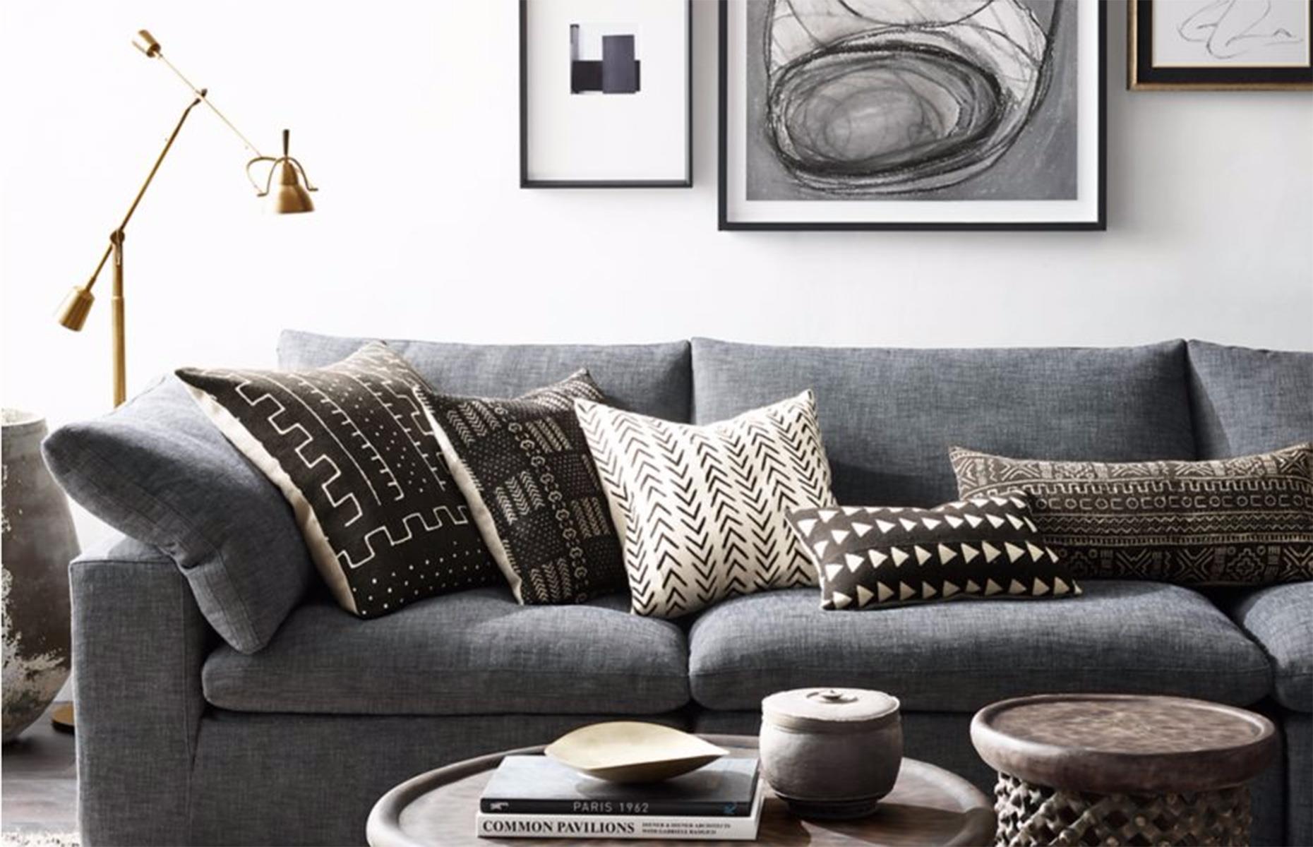 A grey sofa with modern tribal cushions 