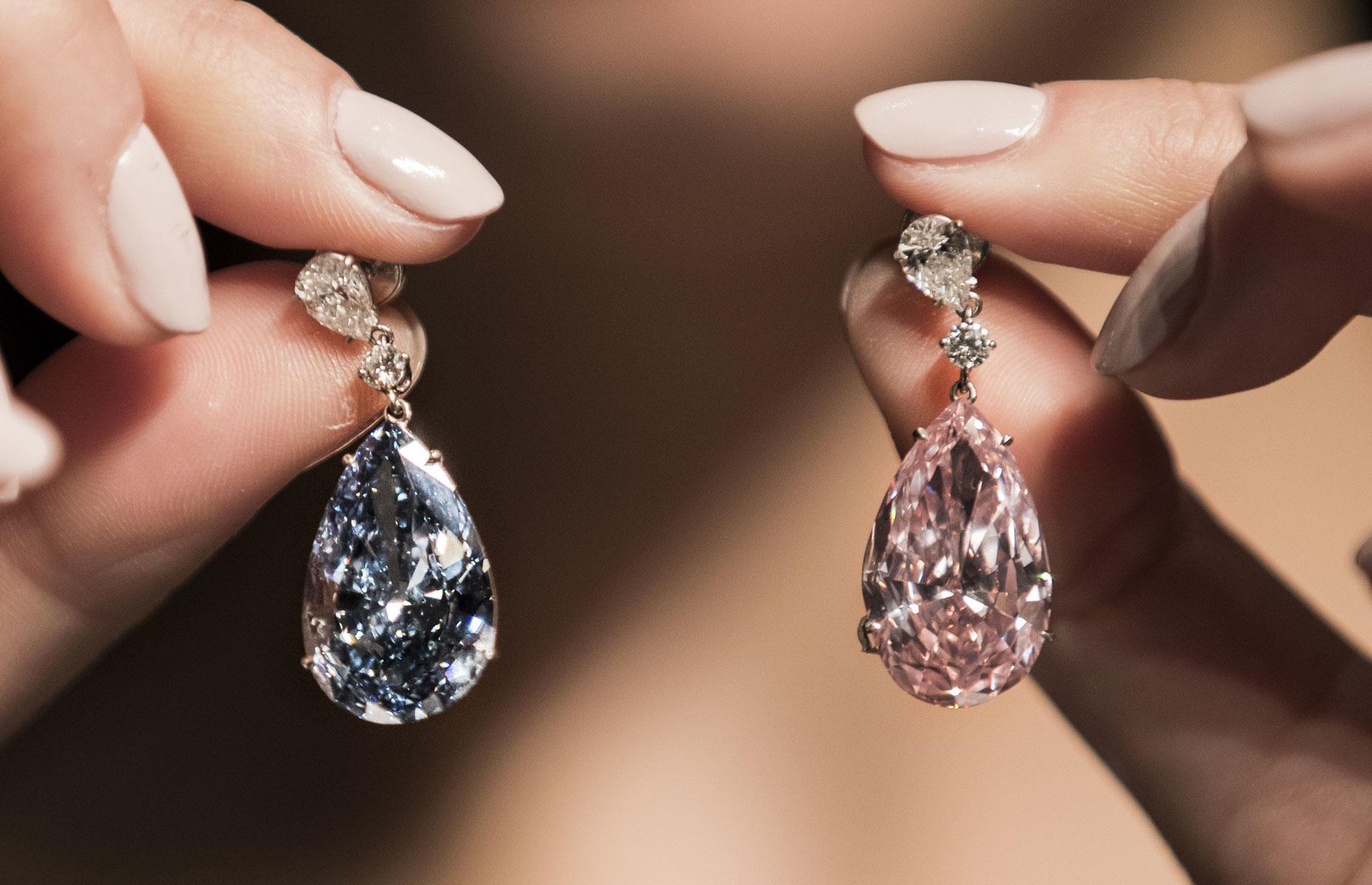 May: a mismatched pair of coloured diamond earrings sells for a record $57.4 million (£43.7m)