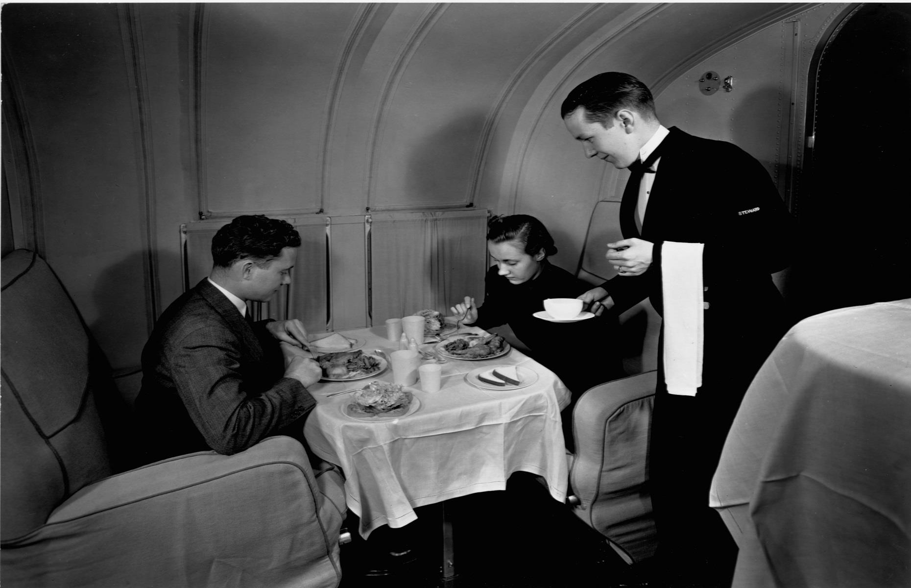 1940s: a couple enjoys dinner aboard the Boeing 314