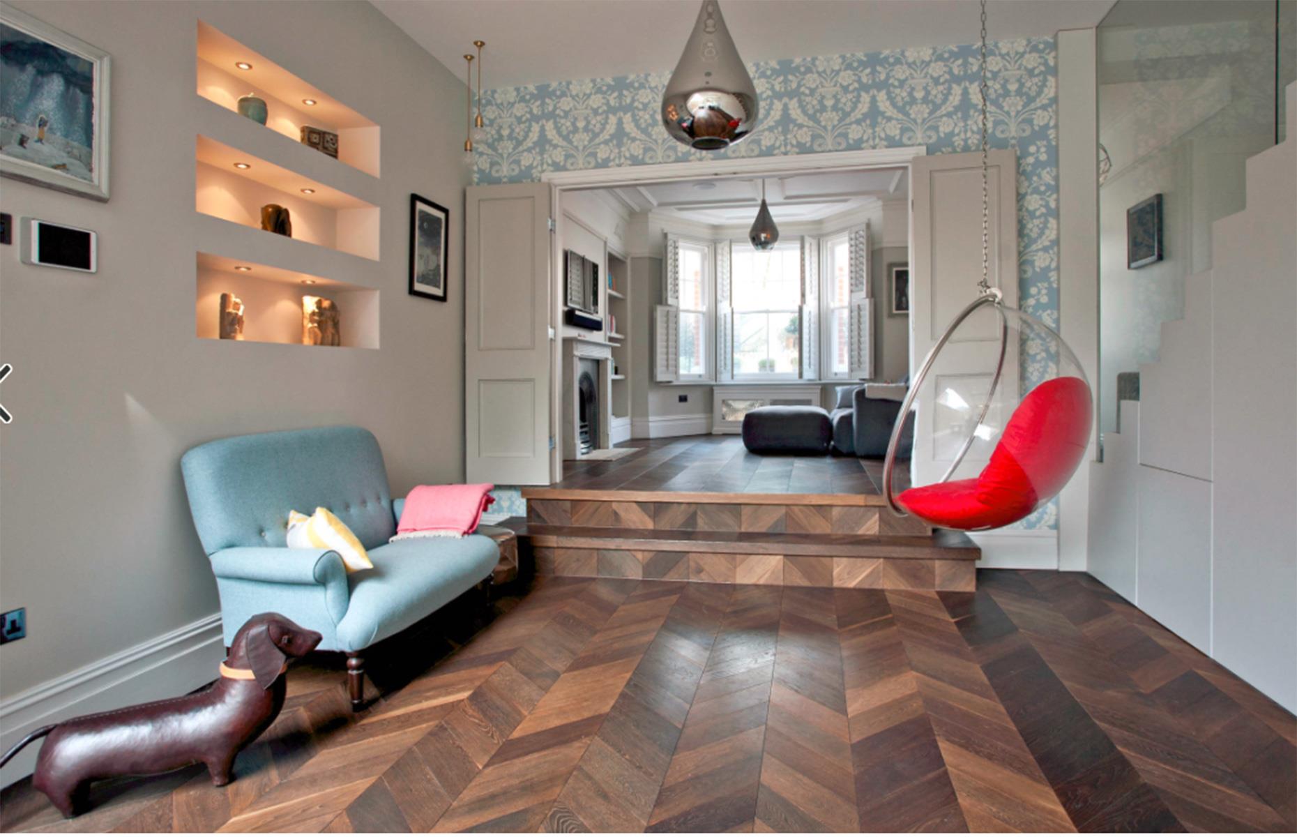 A contemporary living room with dark wood parquet floor