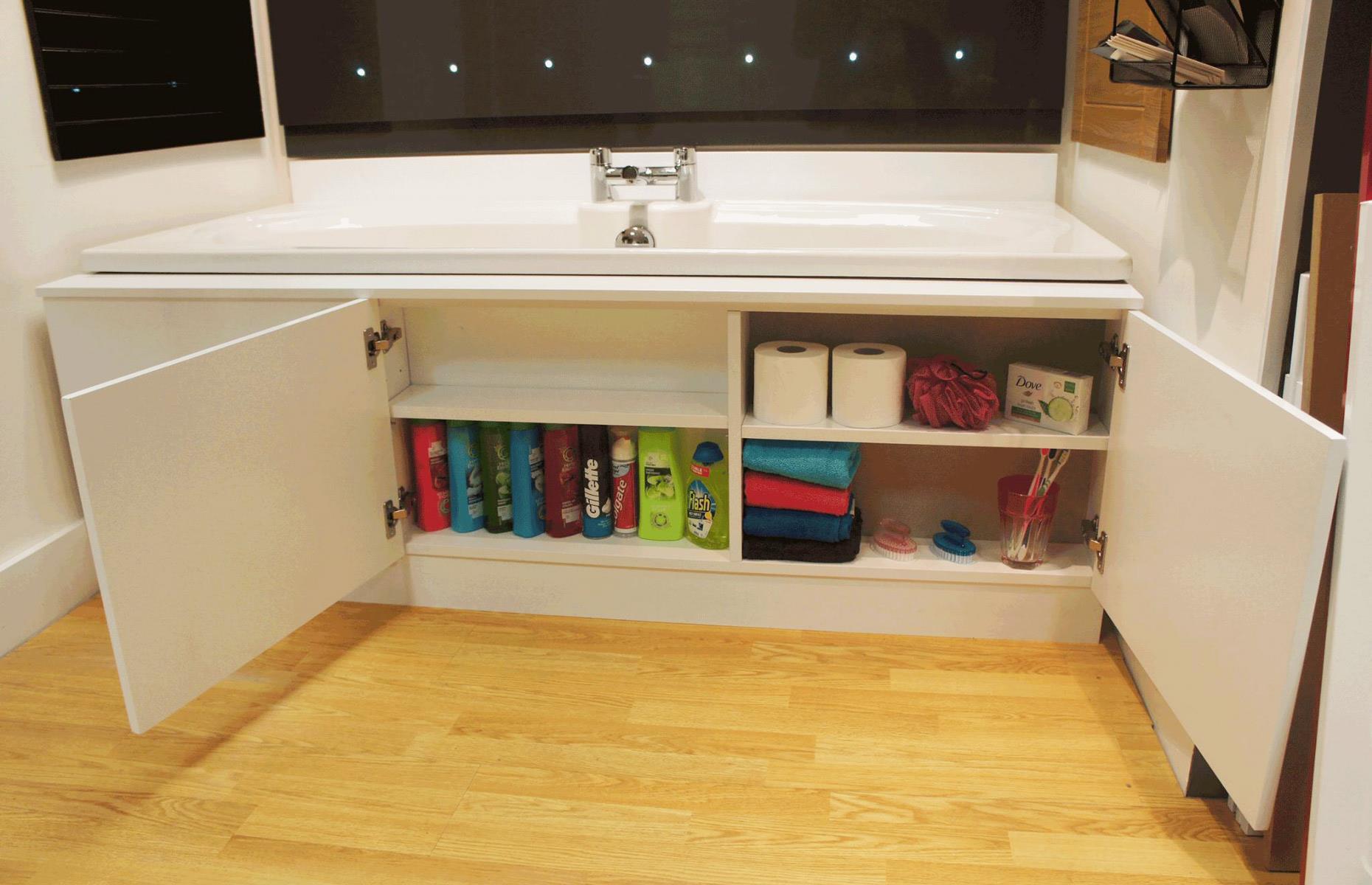Store cleaning products behind the bath panel