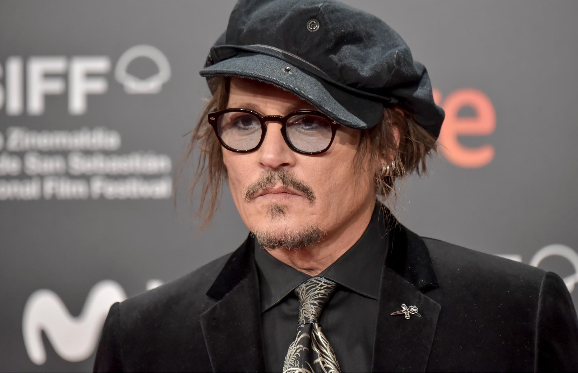 Johnny Depp plays with Barbie dolls 