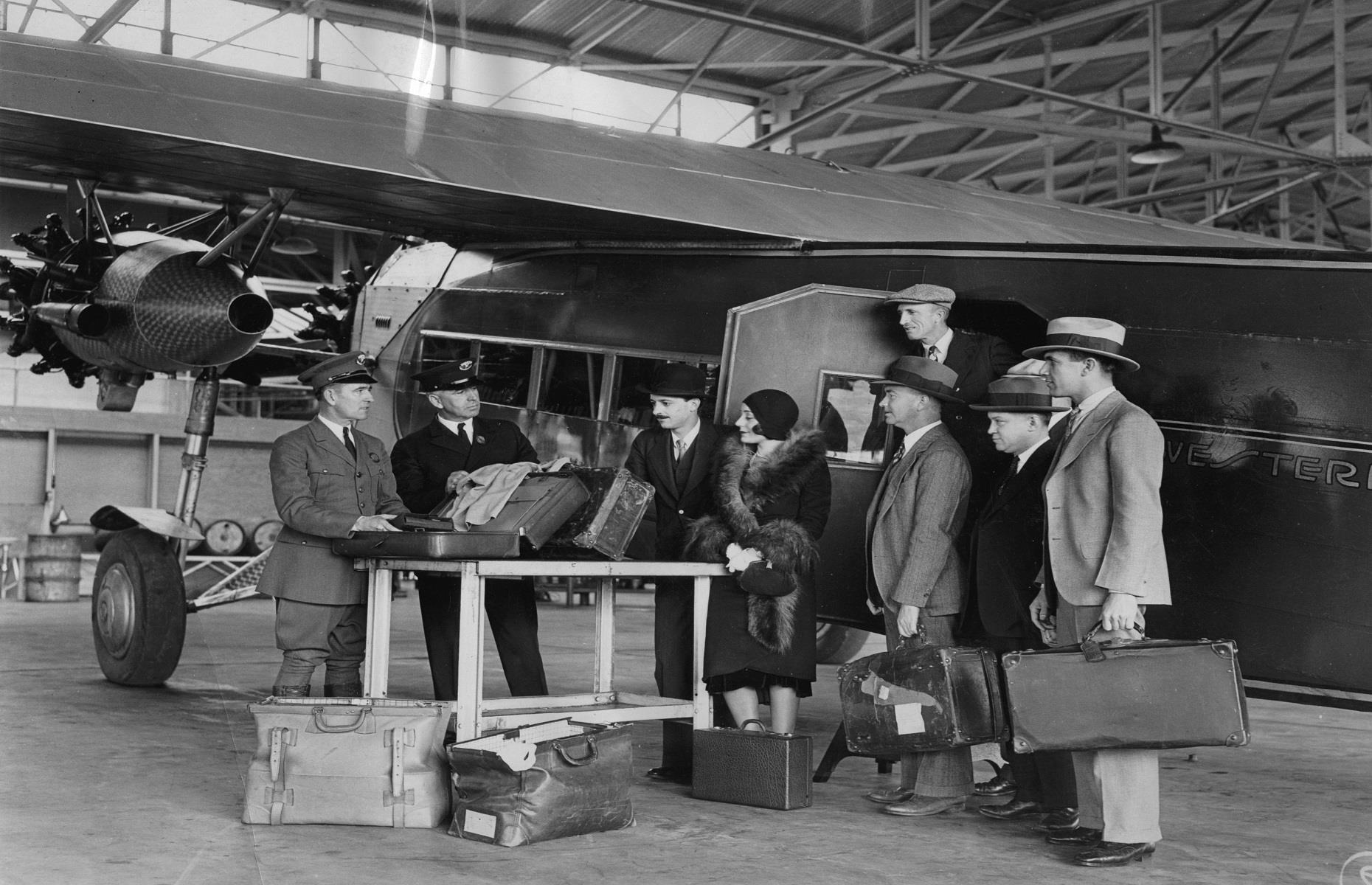 1930s: crew members check bags before a flight to LA