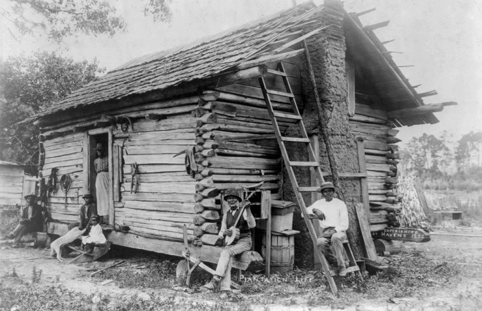 1892: a family outside their log cabin