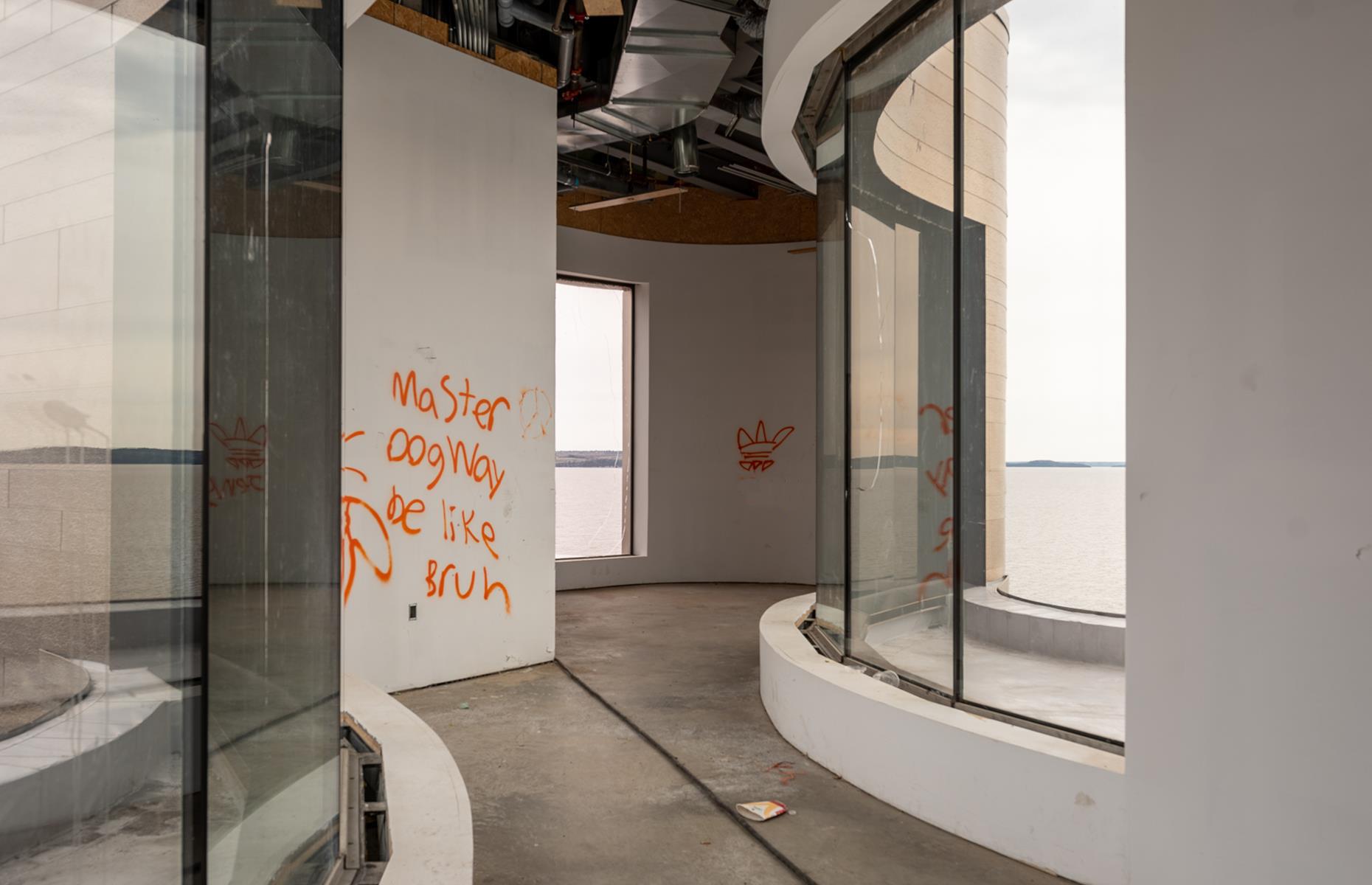 A winding, graffitied corridor