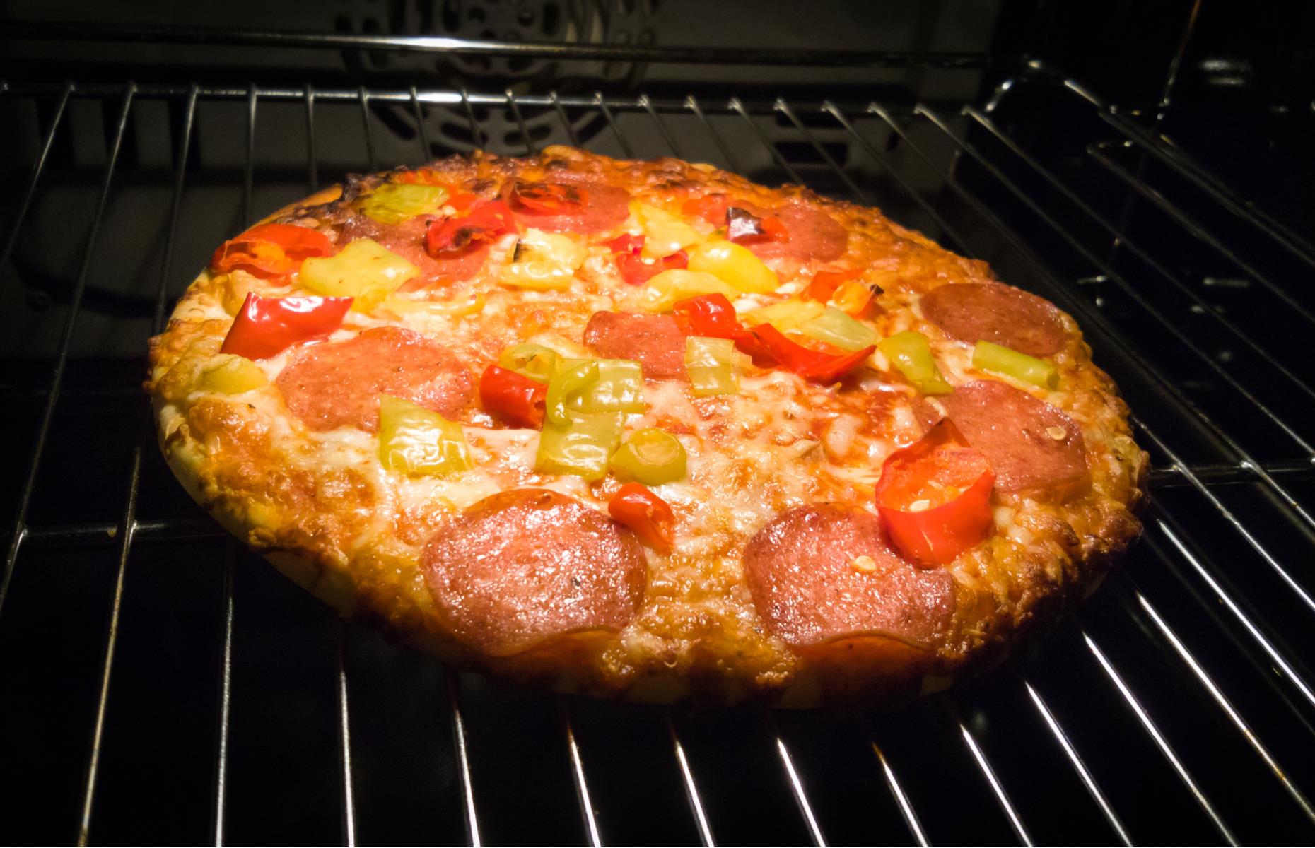 Place frozen pizzas on the rack