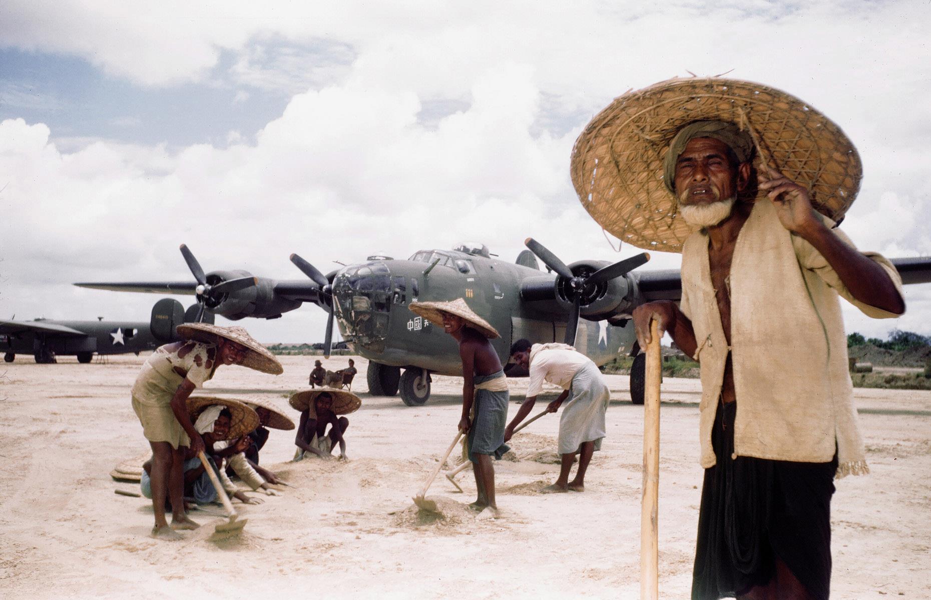 c 1943: local men hoe a US air strip in Assam, India 