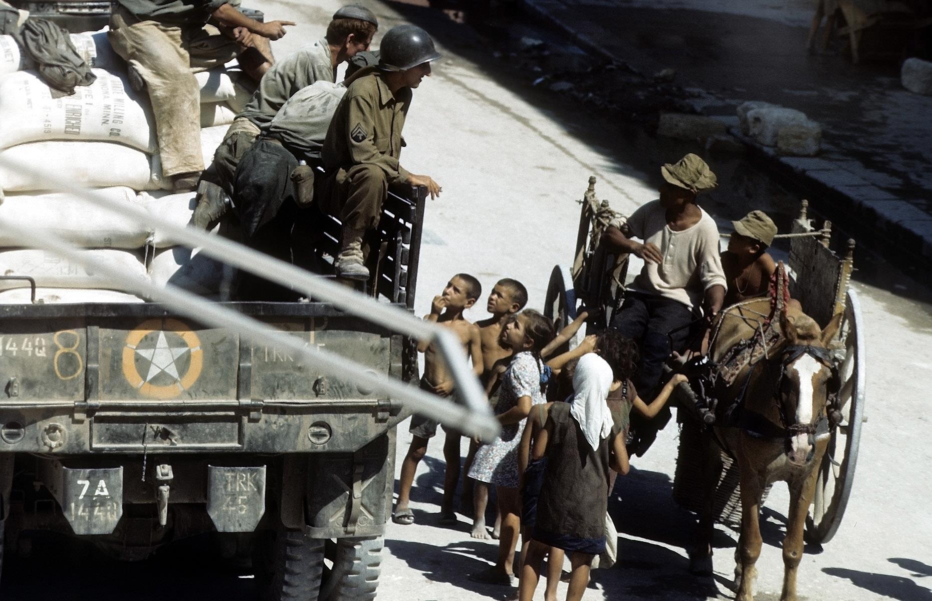 August 1943: children greet Allied troops in Sicily, Italy