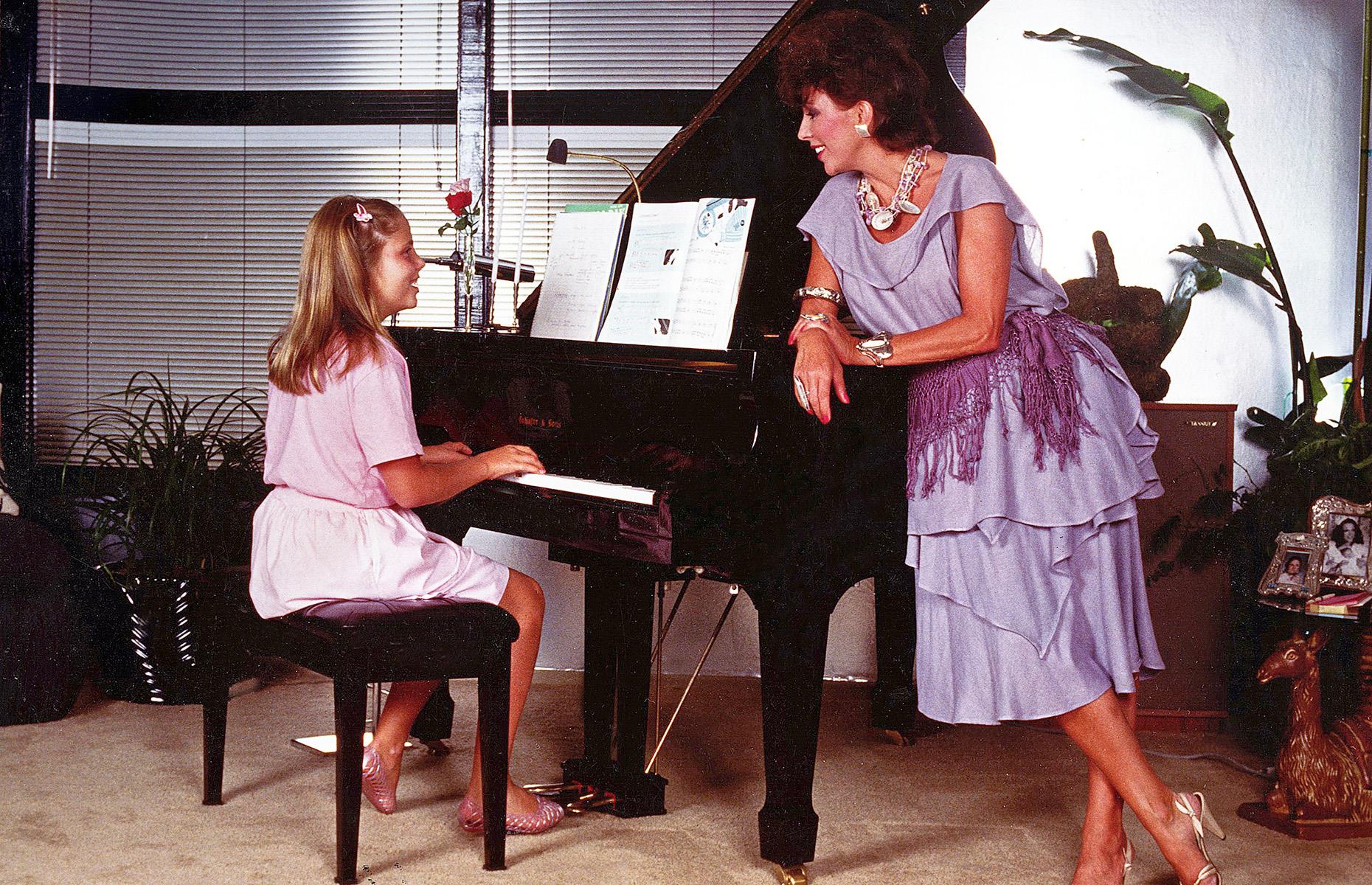 Joan Collins at the piano