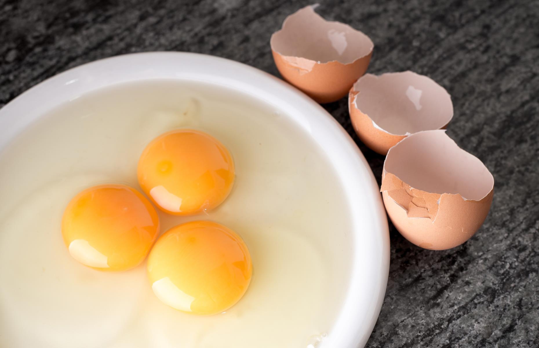 Crack eggs into a cup