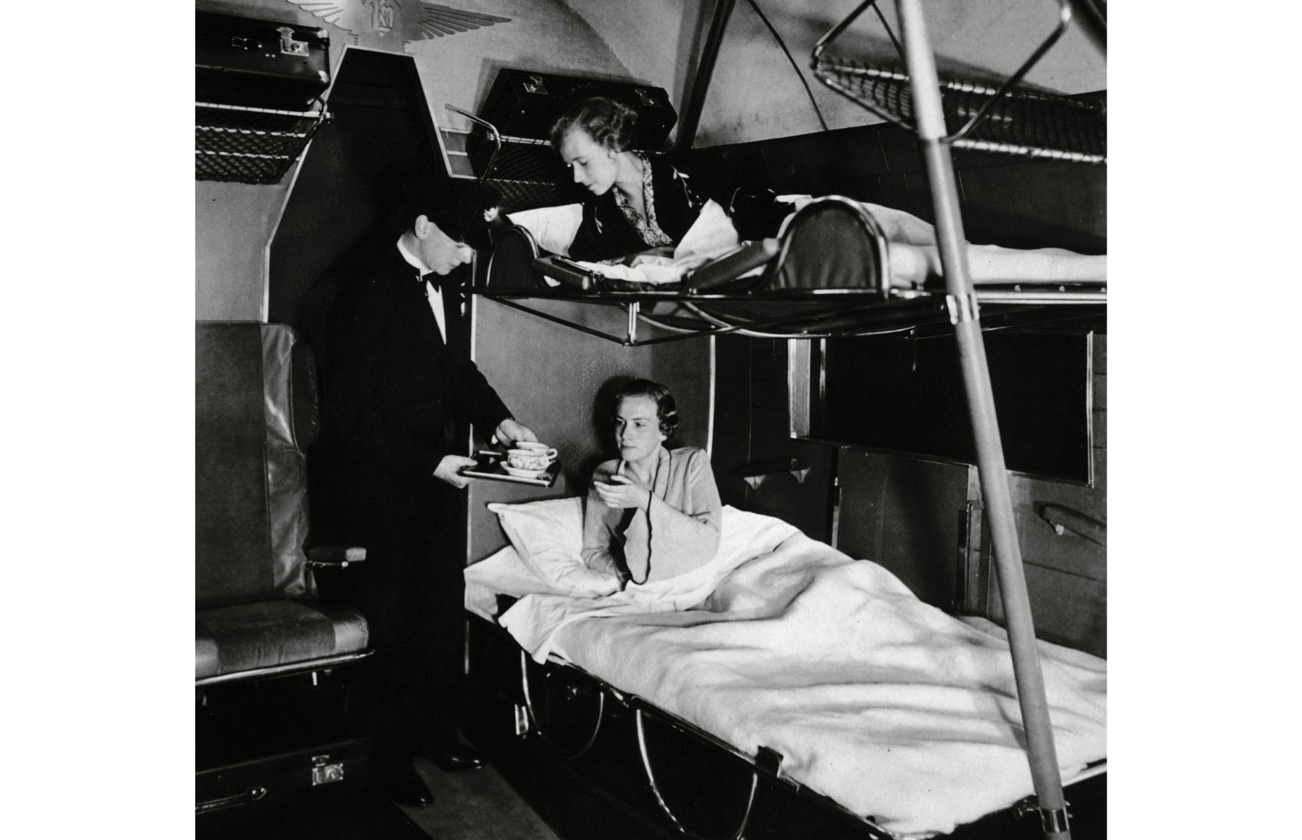 1930s: a flight attendant serves tea in bed