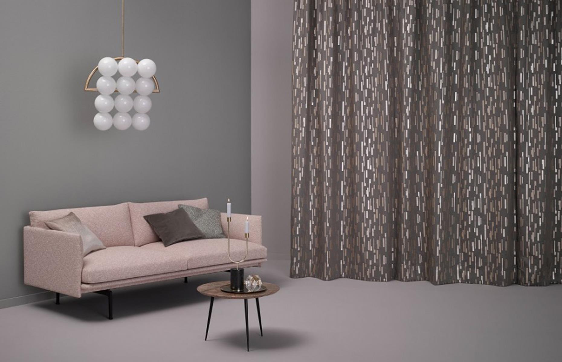 A neutral contemporary living room with embellished metallic curtain