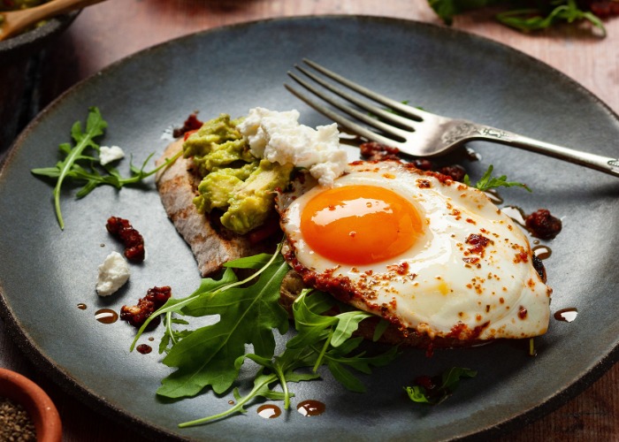 Red pesto fried eggs on sourdough with ricotta and smashed avocado recipe