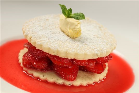 Redcurrant-soaked strawberries and cracked black pepper biscuits recipe